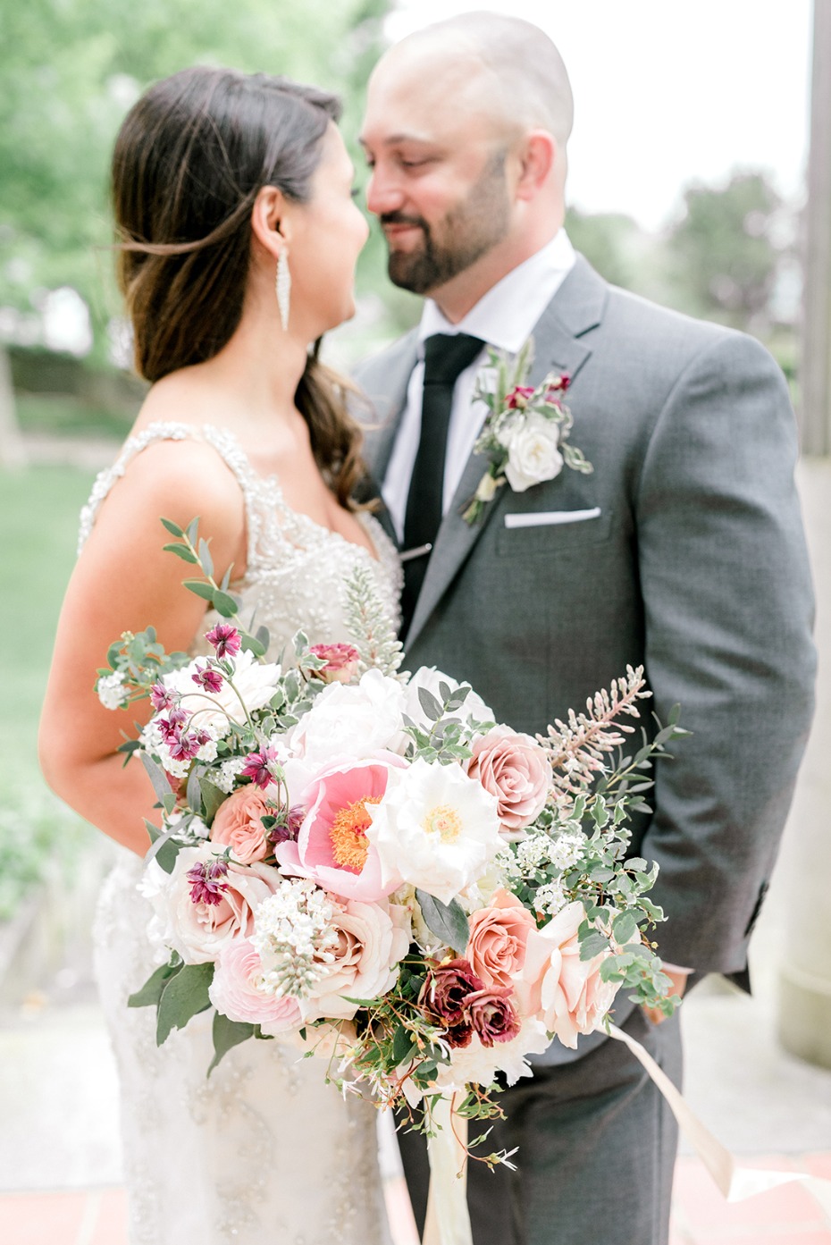 Happy wedding couple in love with beautiful bouquet