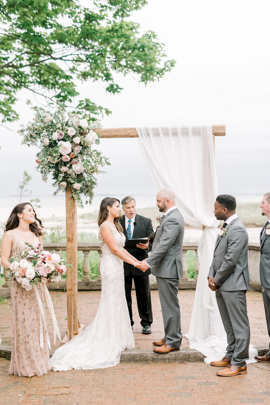 Elegant outdoor wedding ceremony with a floral arch