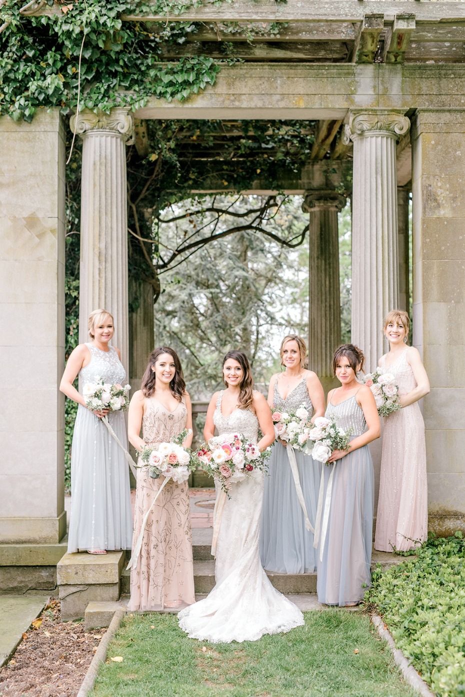 Bride and bridesmaids pose for photo during a wedding ceremony