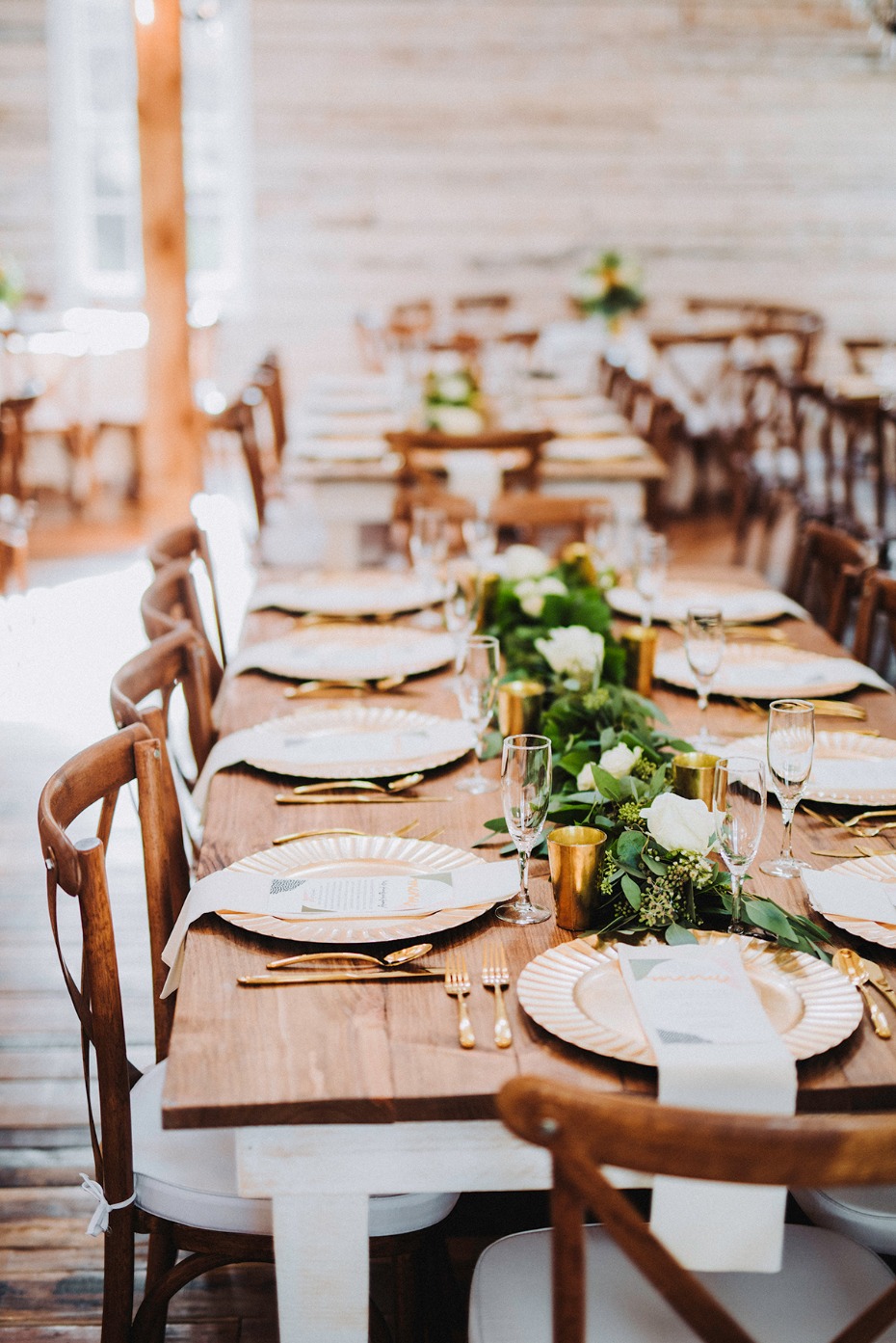 wedding table decor with farm table and gold flatware