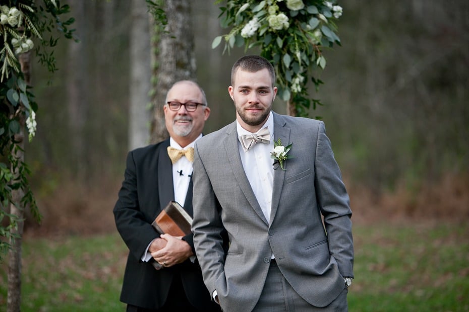 groom in grey and neutral bow tie