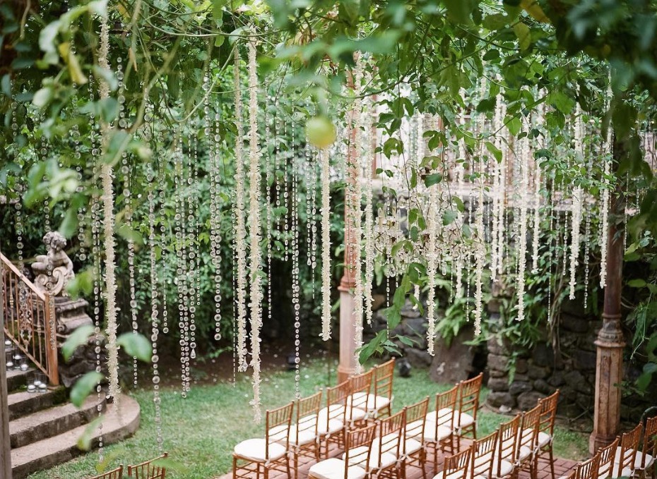 Elegant outdoor wedding with floral decorations and chairs