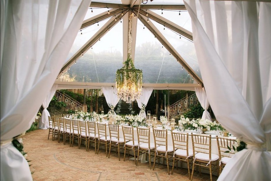 Elegant tented wedding reception with white flowers