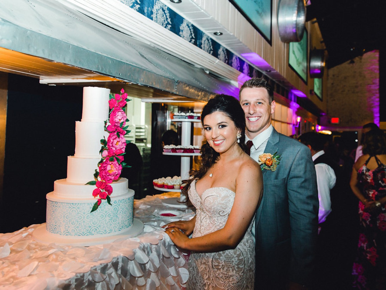 cute candid wedding couple and their wedding cake