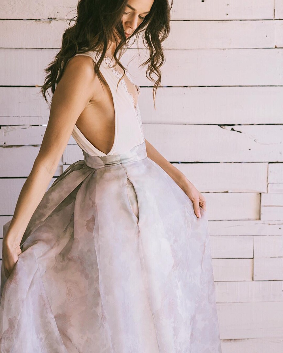 Woman in watercolor print gown with low back