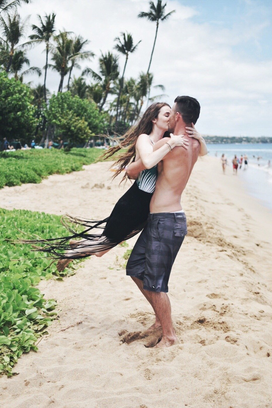 Couple kissing on the beach on honeymoon