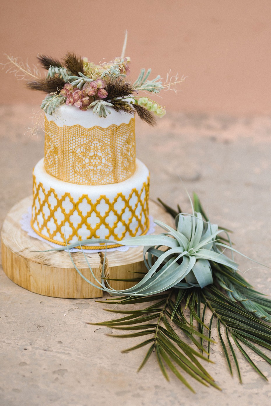 gold cake with air plant