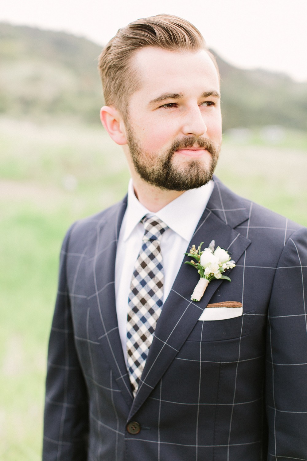 groom in navy checked suit