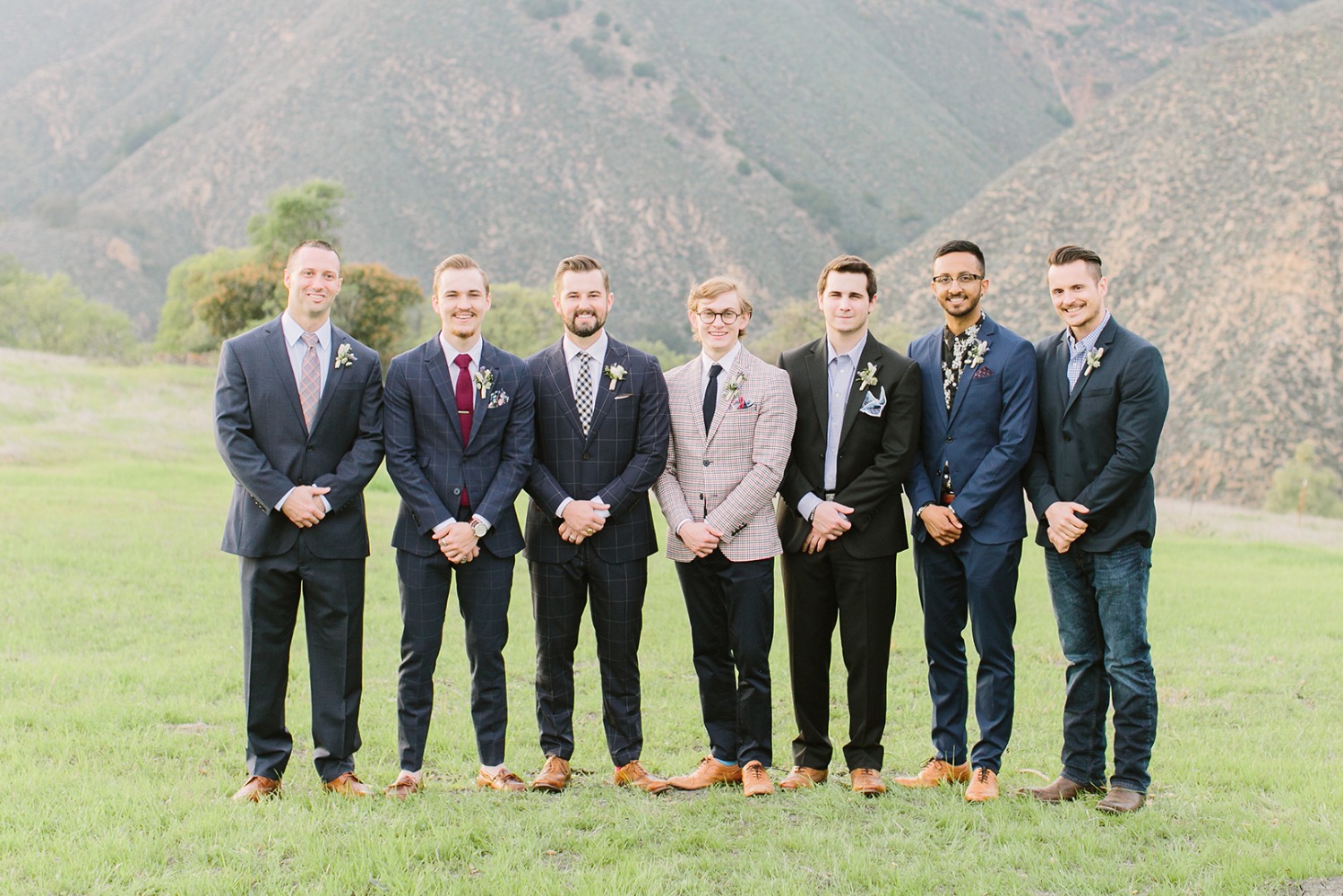groomsmen in mismatched wedding suits