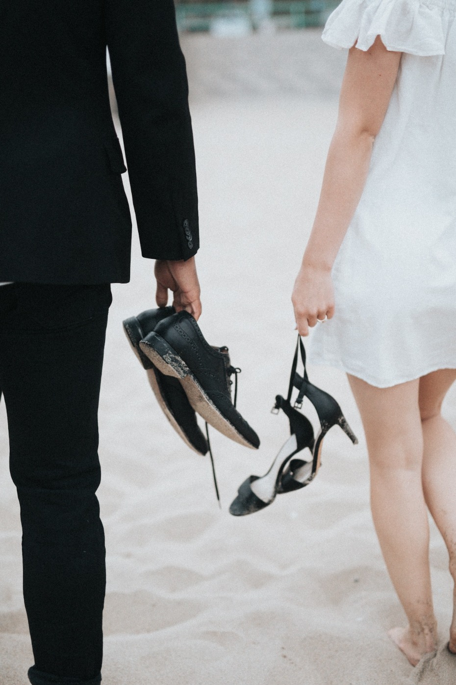 Bride and groom barefoot on the beach