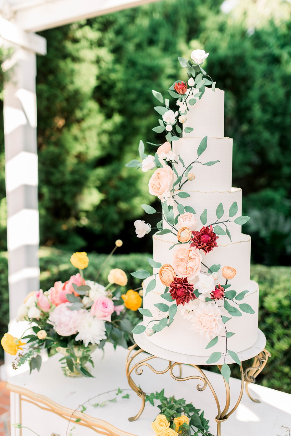 Elegant wedding cake with floral decorations outdoor