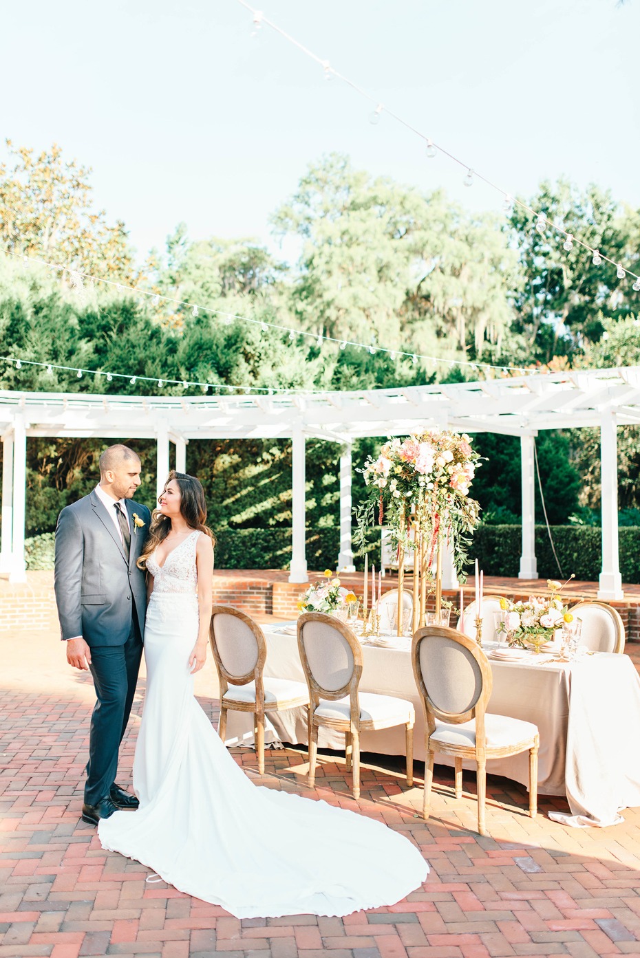 Bride and groom at outdoor wedding reception table