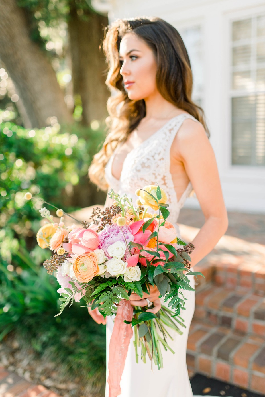 Bride holding colorful flower bouquet outdoors