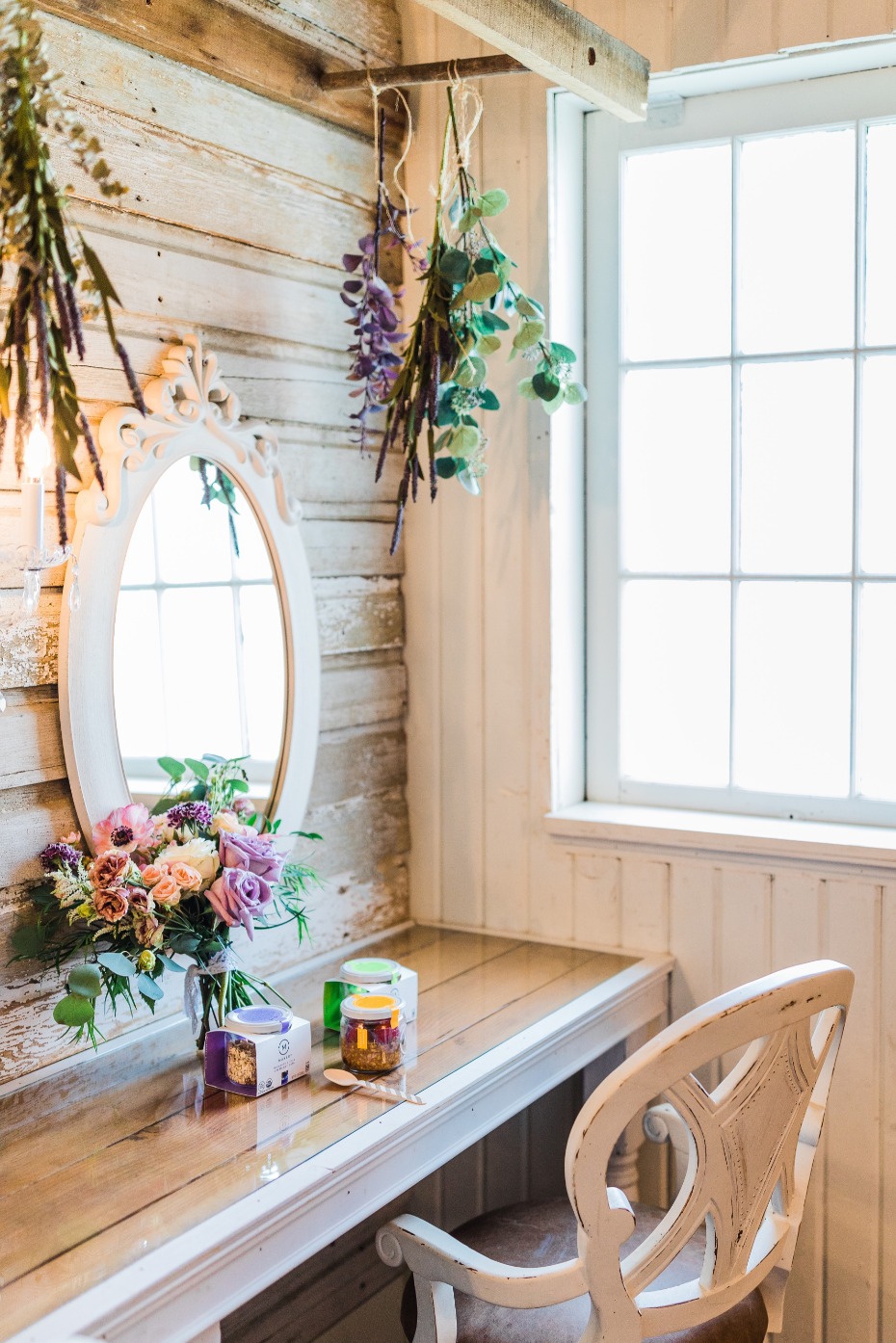 Charming vanity space with flowers, mirror and natural light
