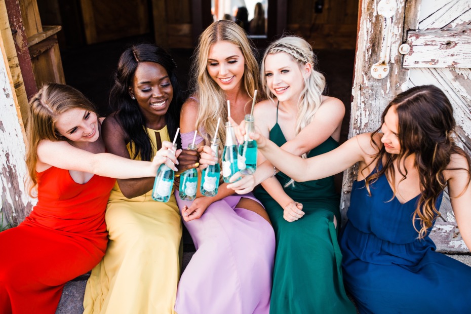 Bridesmaids toasting with mini bottles