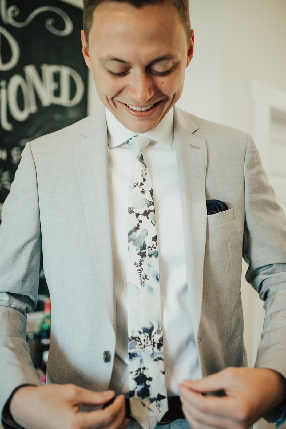 groom in grey and watercolor tie