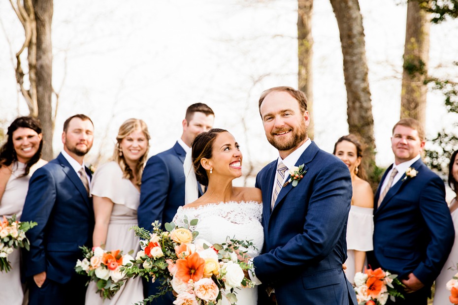 Bride groom and wedding party outdoor portrait smiling