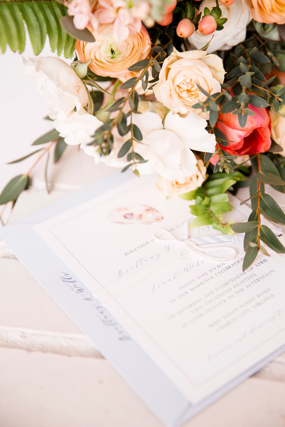 Wedding invitation with bouquet of pastel colored flowers