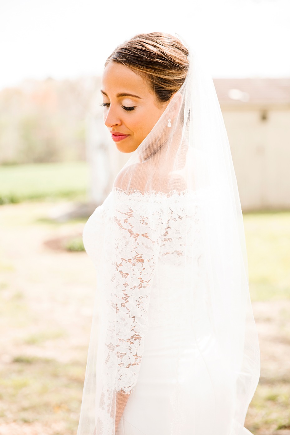 Elegant bride in a lace wedding dress with a veil, smiling