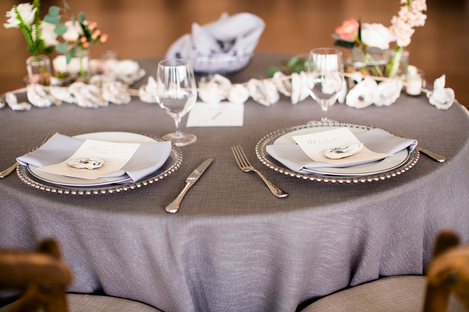 Elegant wedding table setting with grey linens plate