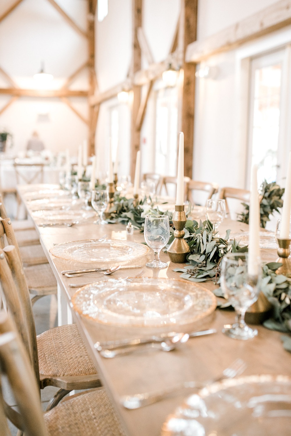 Elegant table setting with candles and greenery for a wedding