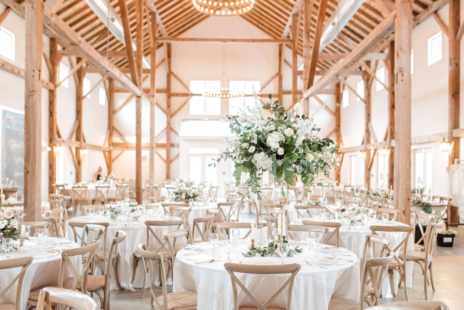 Elegant wedding reception tables in a rustic barn venue