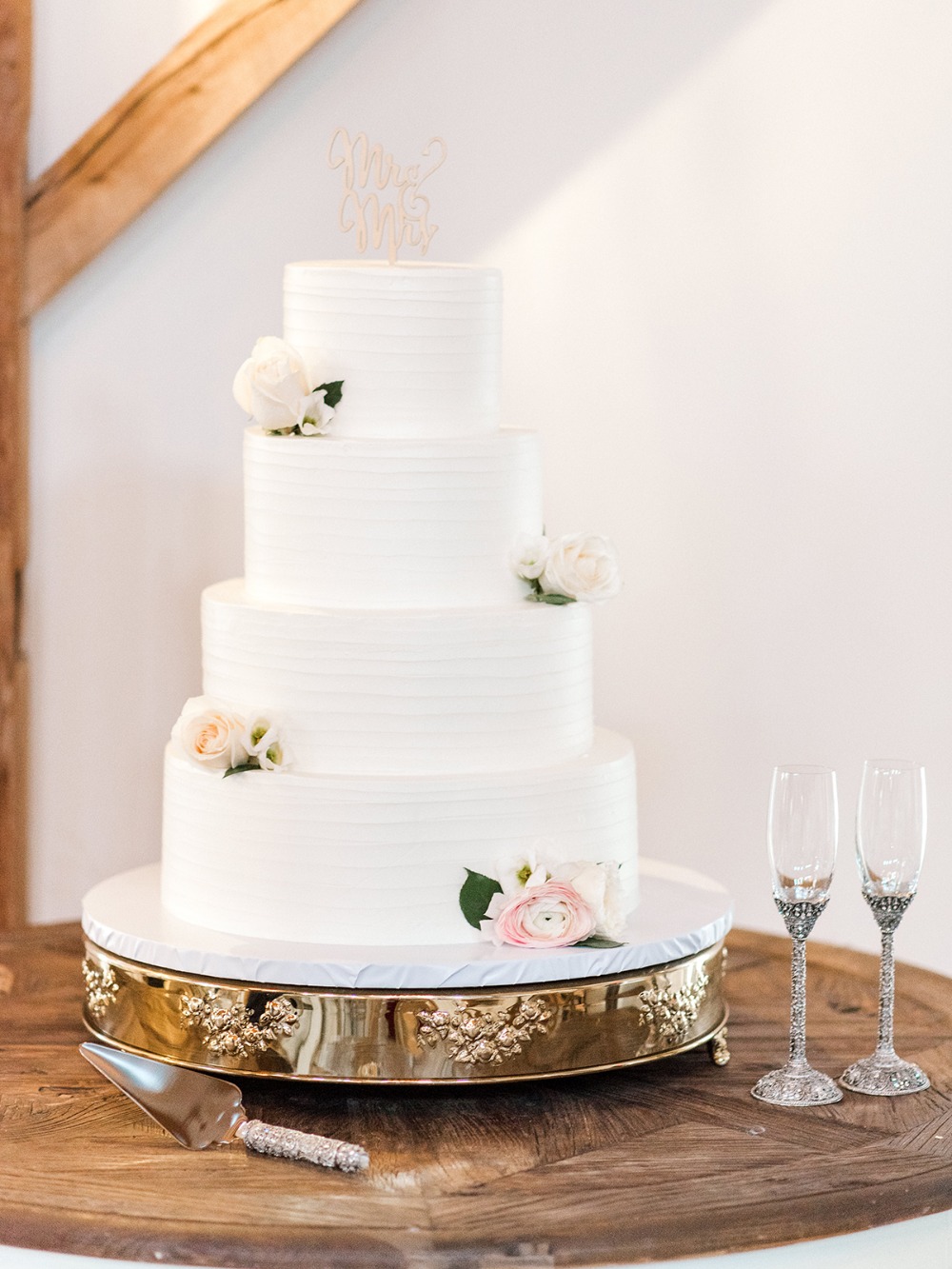 Elegant wedding cake with flowers and glasses on a table
