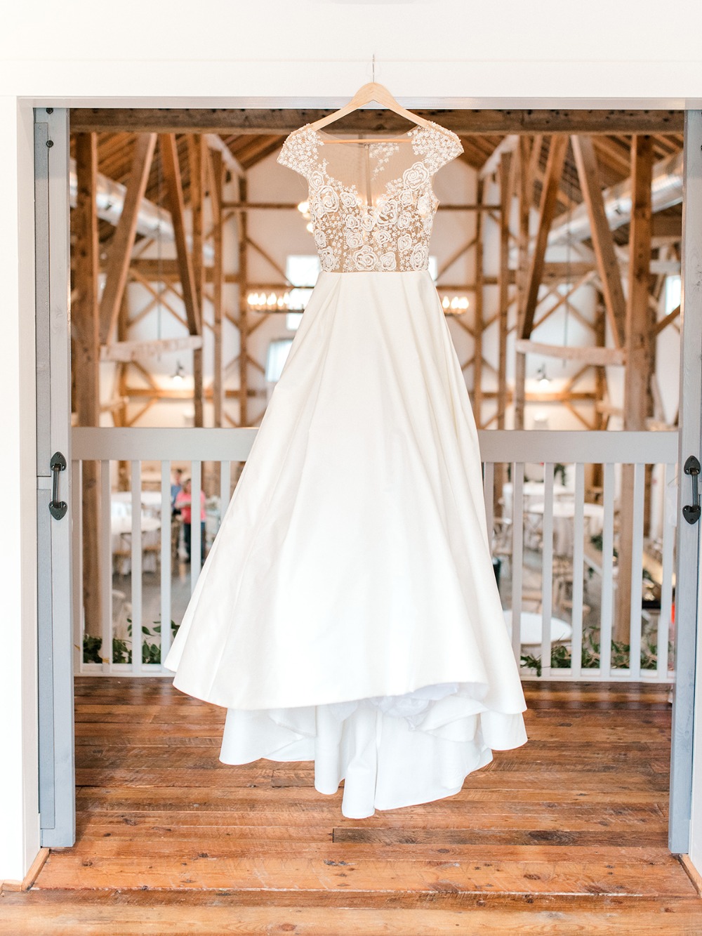 Elegant wedding dress hanging at the barn wedding venue