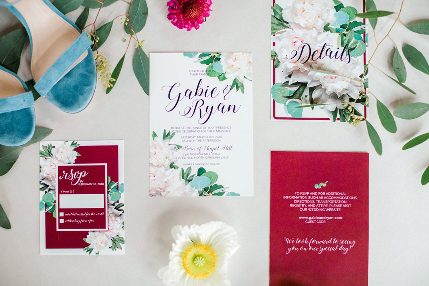Elegant wedding invitation with shoes and floral details, close up