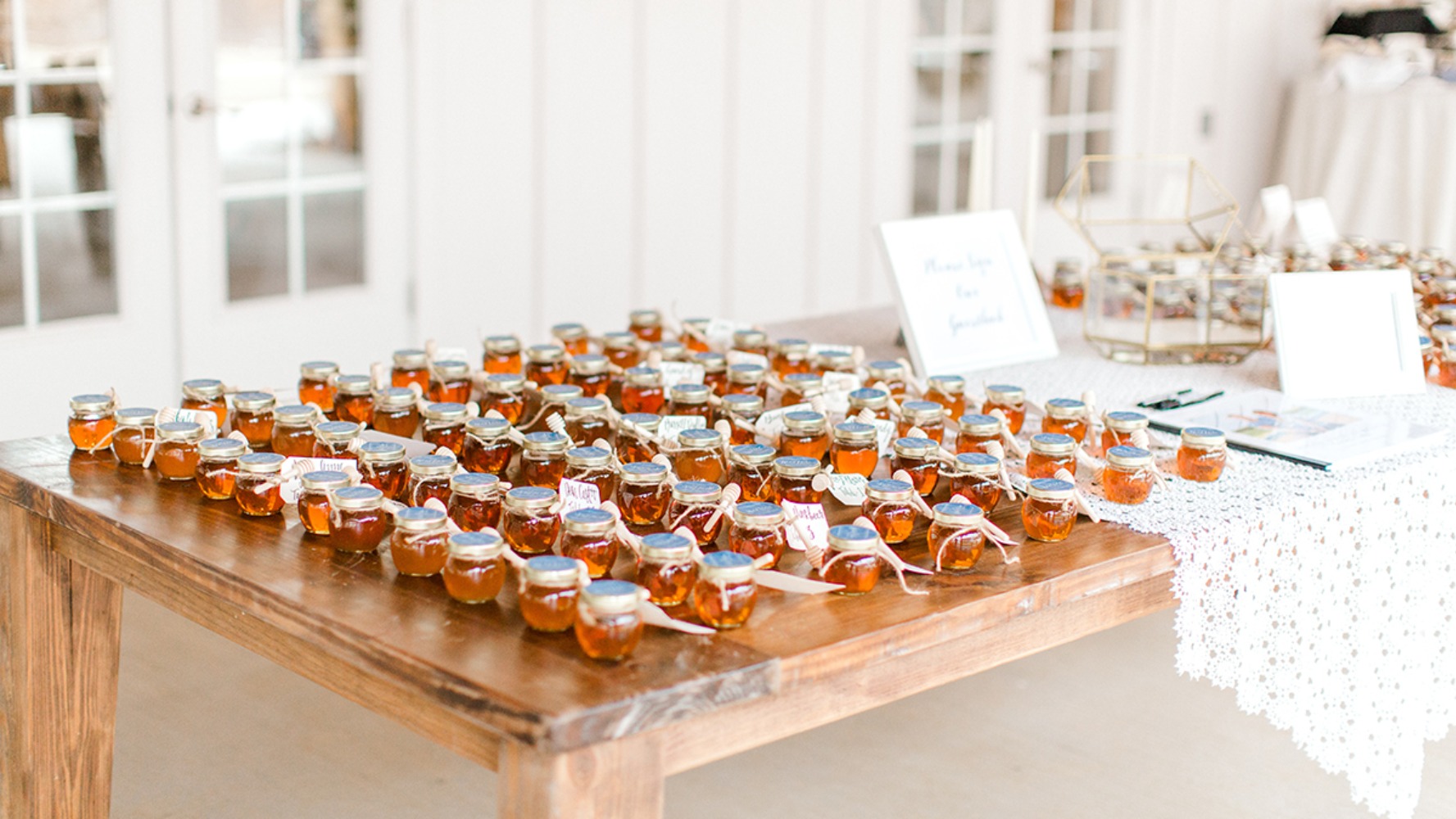 Small jars of honey with wooden spoons, wedding favors decor