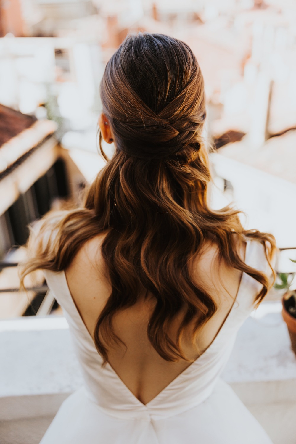 Elegant hairstyle on a woman wearing a backless white dress