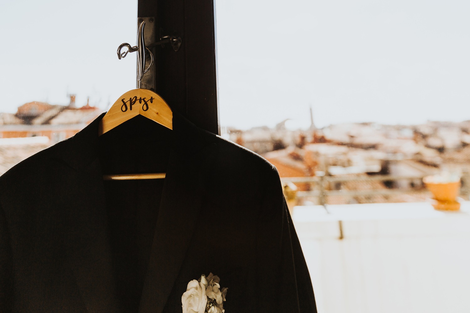 Elegant black blazer hanging with cityscape in background
