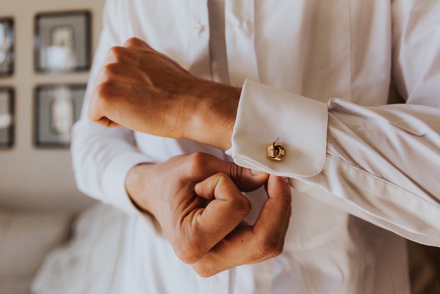 Man adjusting his cufflink, getting ready for an event