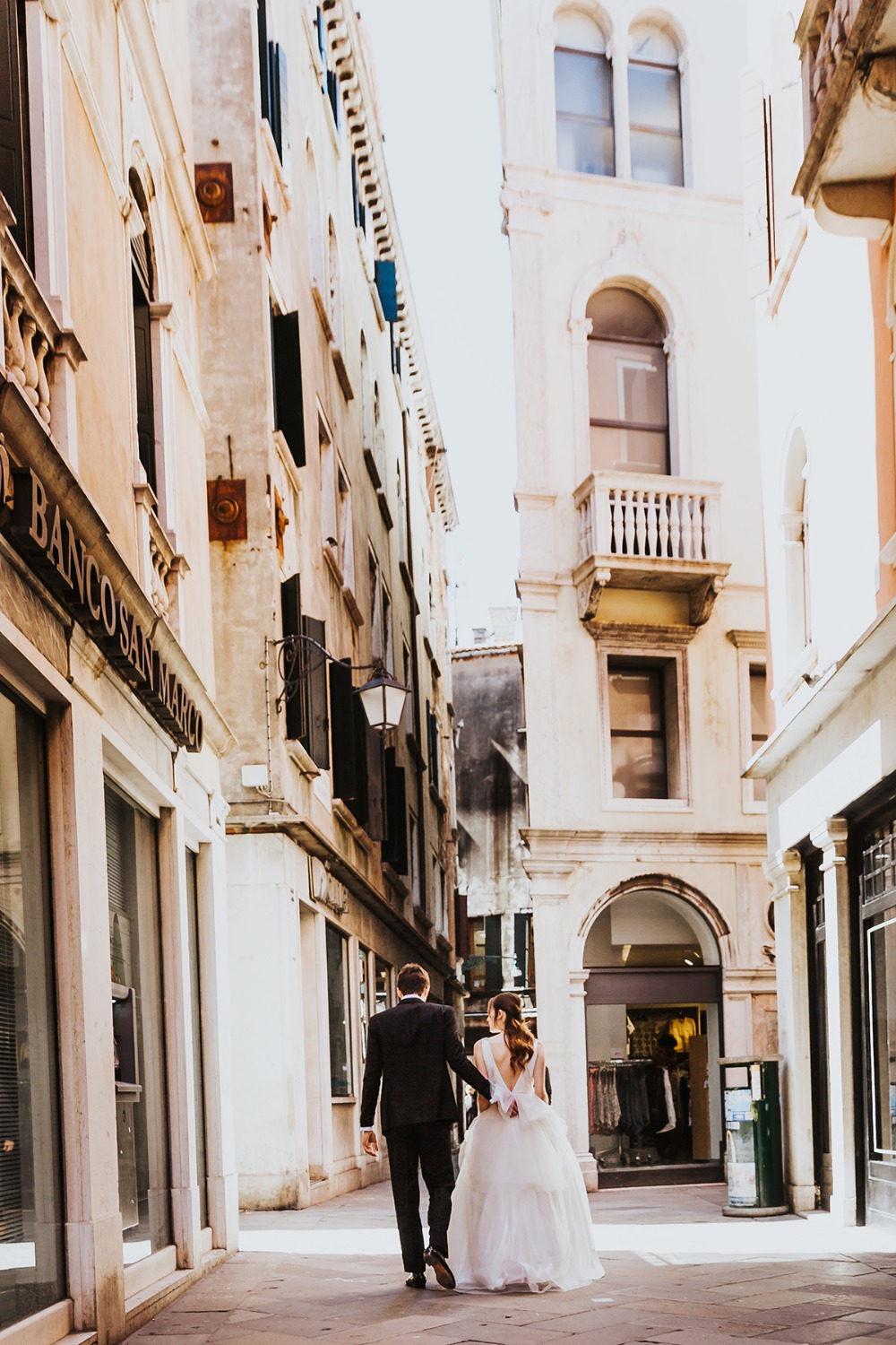 Newlyweds walking in Venice, a romantic stroll through old streets