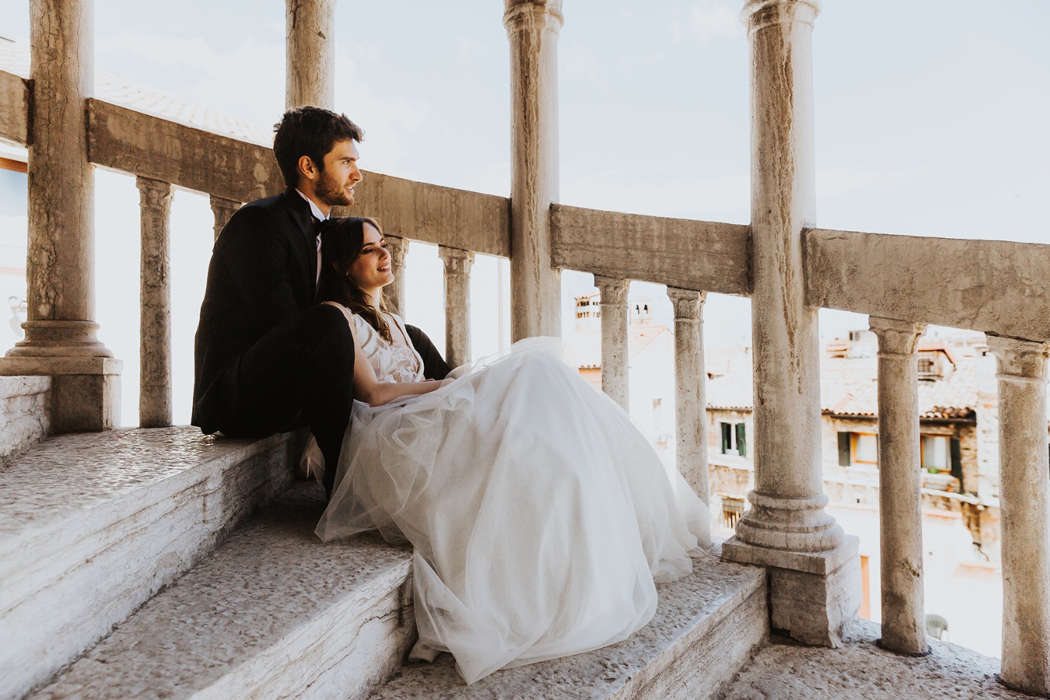 Bride and groom on stone stairs in romantic Venice
