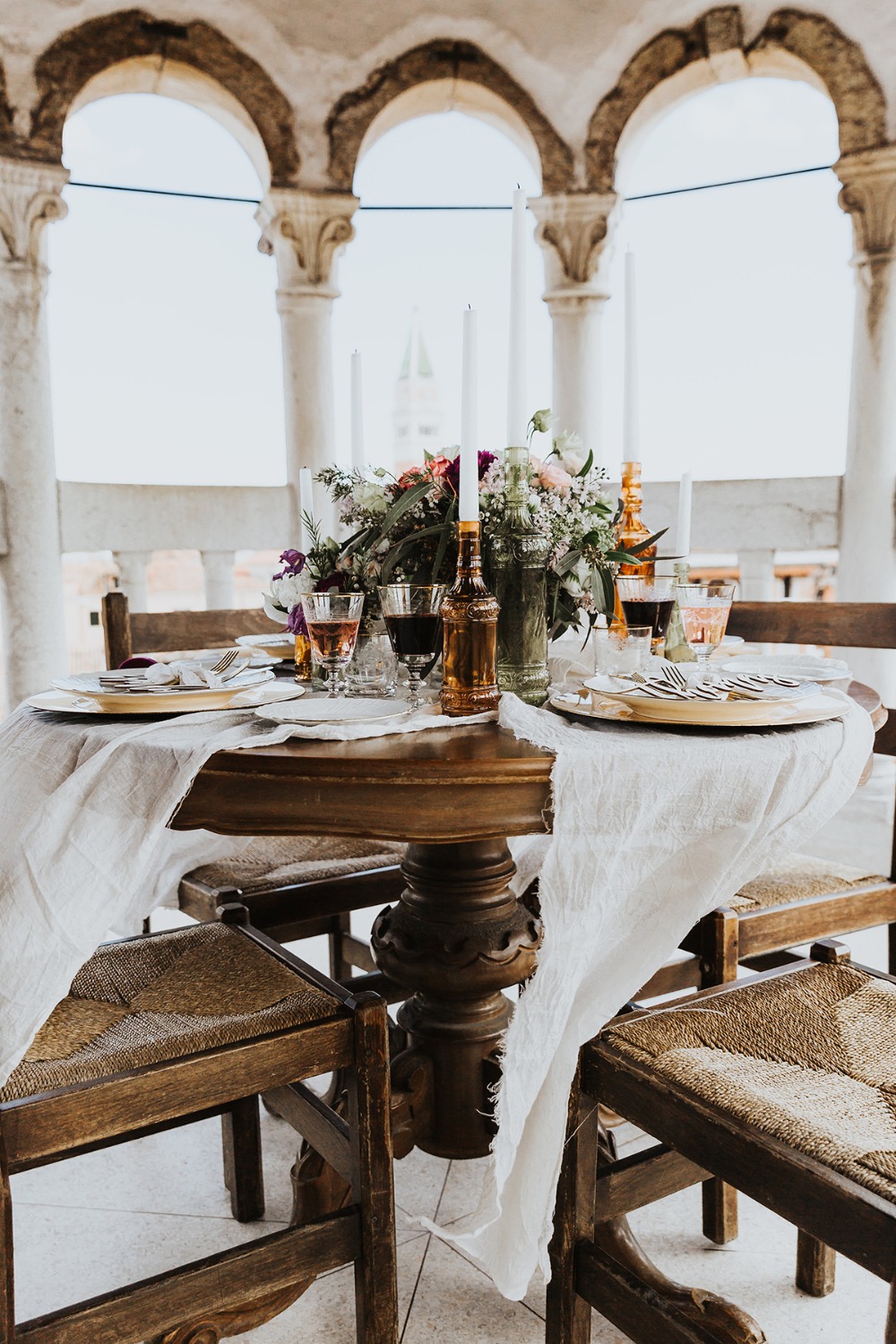 Elegant tablescape with flowers candles and arched columns