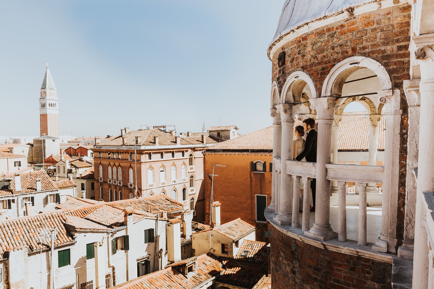 Venice wedding couple on balcony overlooking rooftops