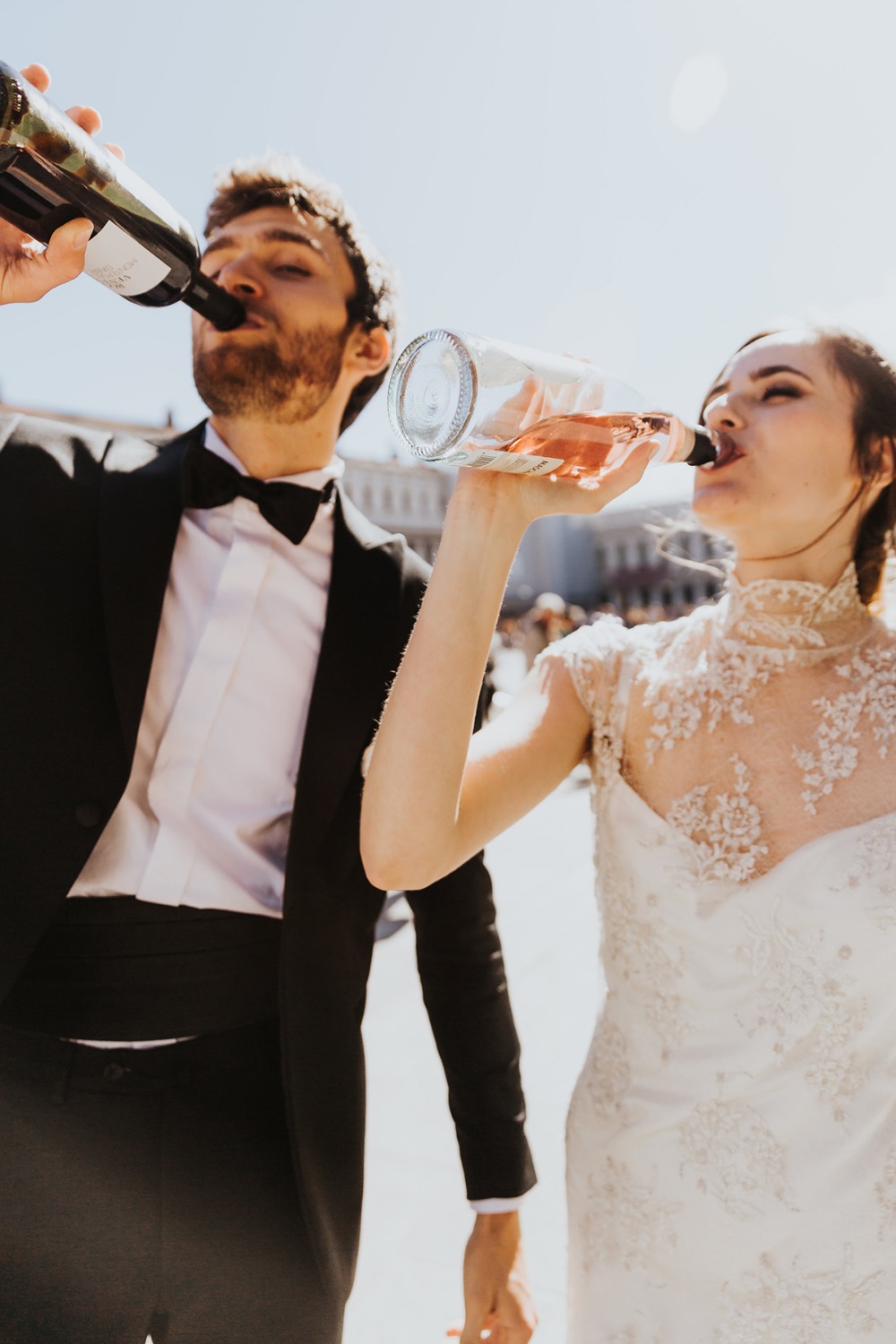 Bride and groom drinking wine after wedding ceremony