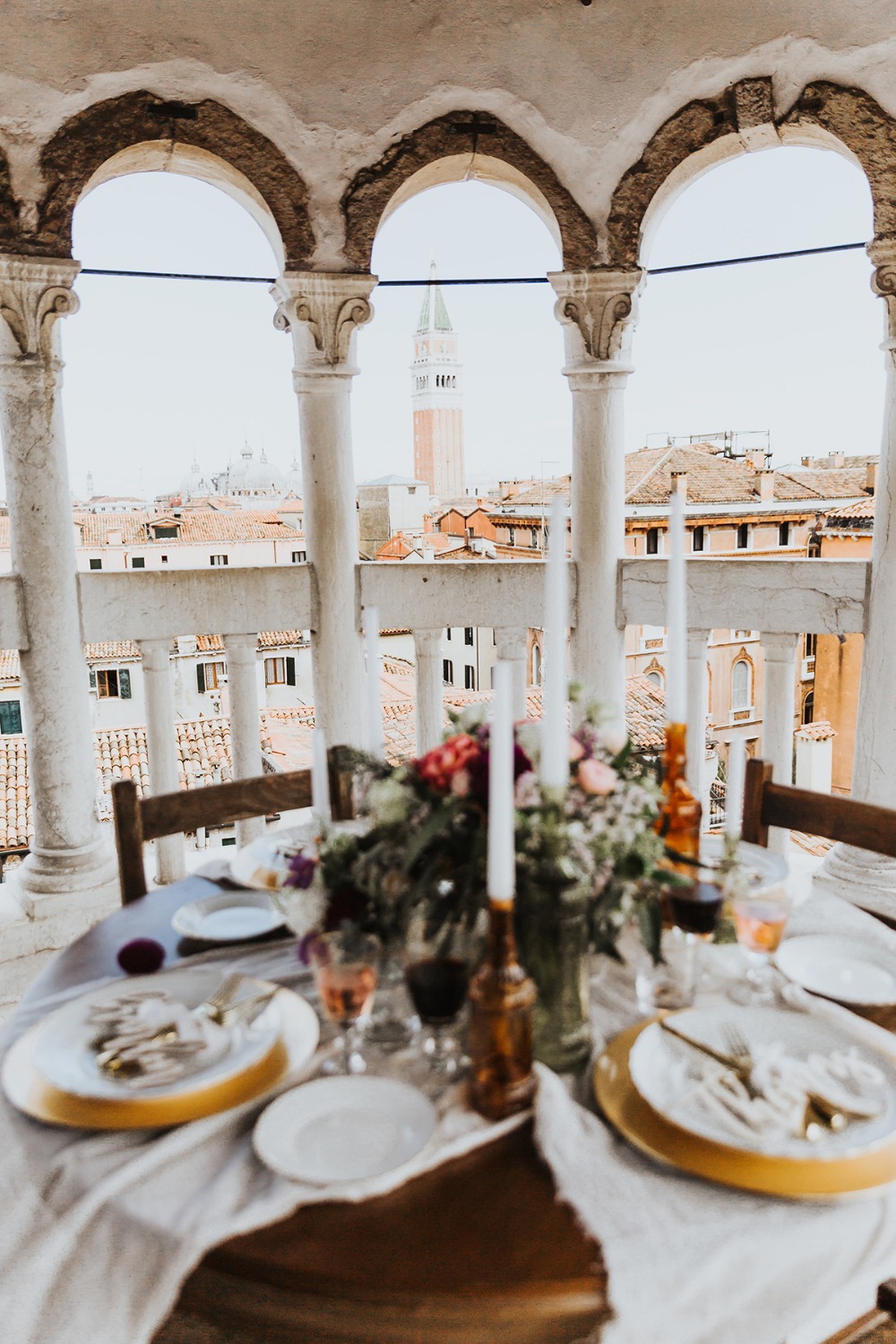 Romantic table set for a meal with Venice view and floral center piece