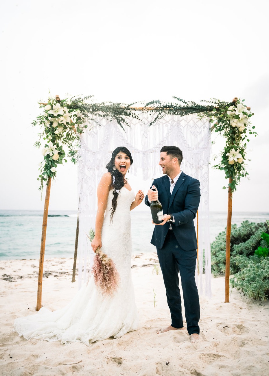 Cayman Island Beach Wedding Bride and Groom Popping Champagne