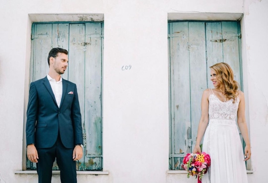Couple staring at each other in front of barn windows