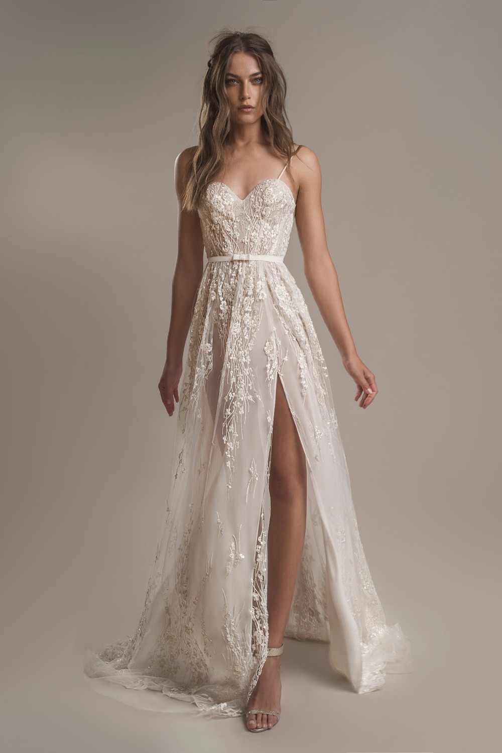 Woman in a romantic white lace wedding dress with slit