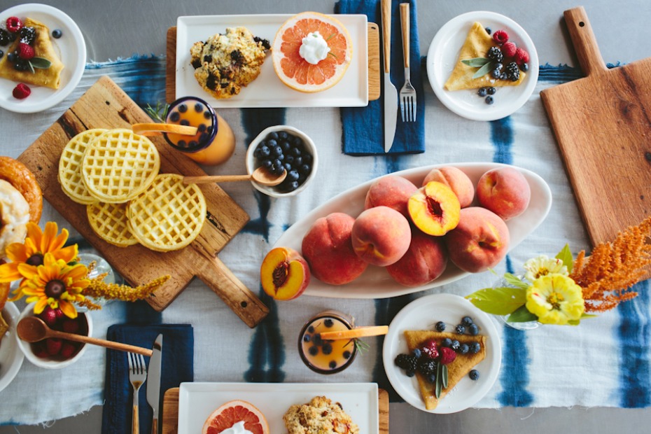 Brunch tablescape with doughnuts waffles and fresh fruit