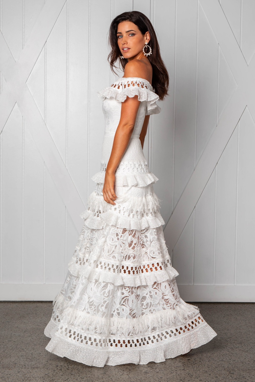 Elegant woman in white lace ruffle maxi dress