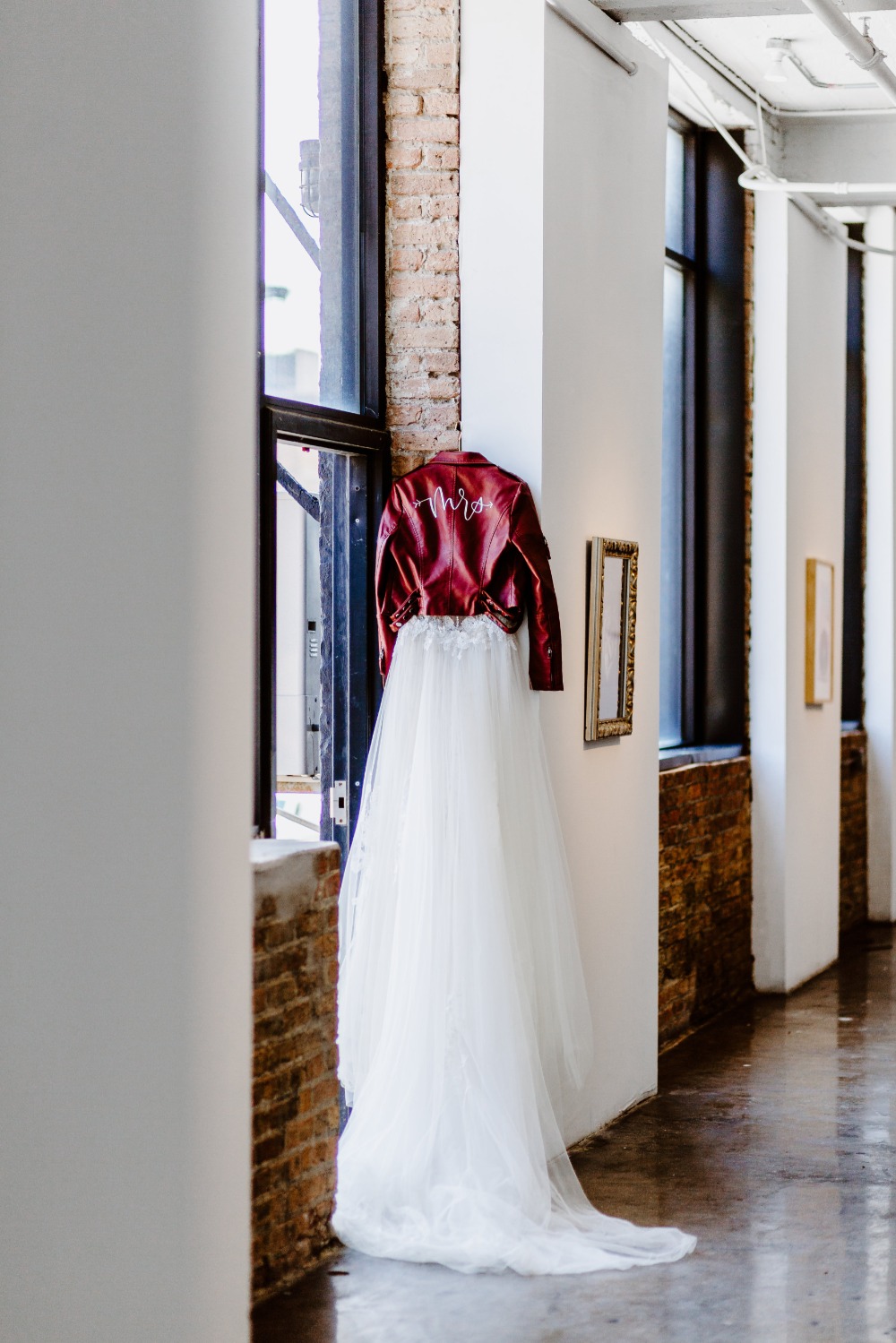 wedding dress and burgundy leather jacket