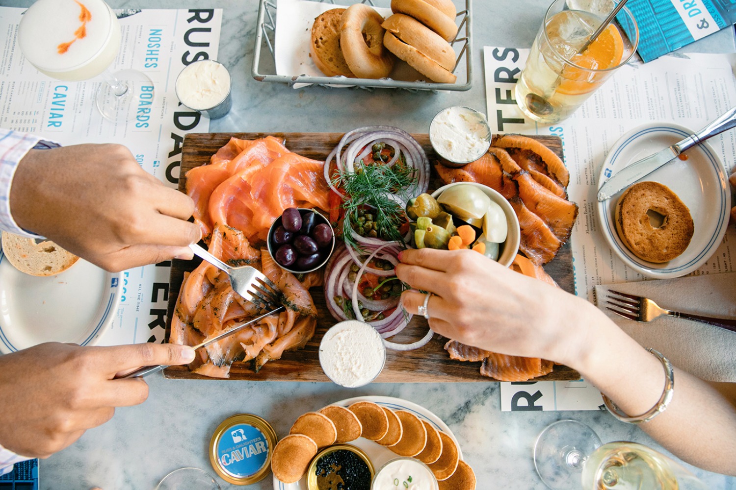 People sharing a delicious smoked salmon platter with bagels