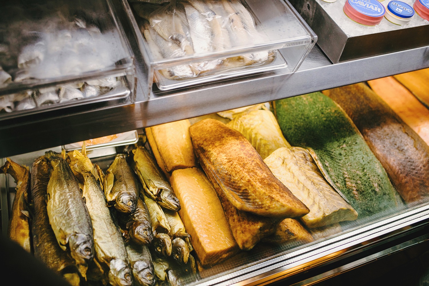 Delicious smoked fish and caviar display in a market showcase