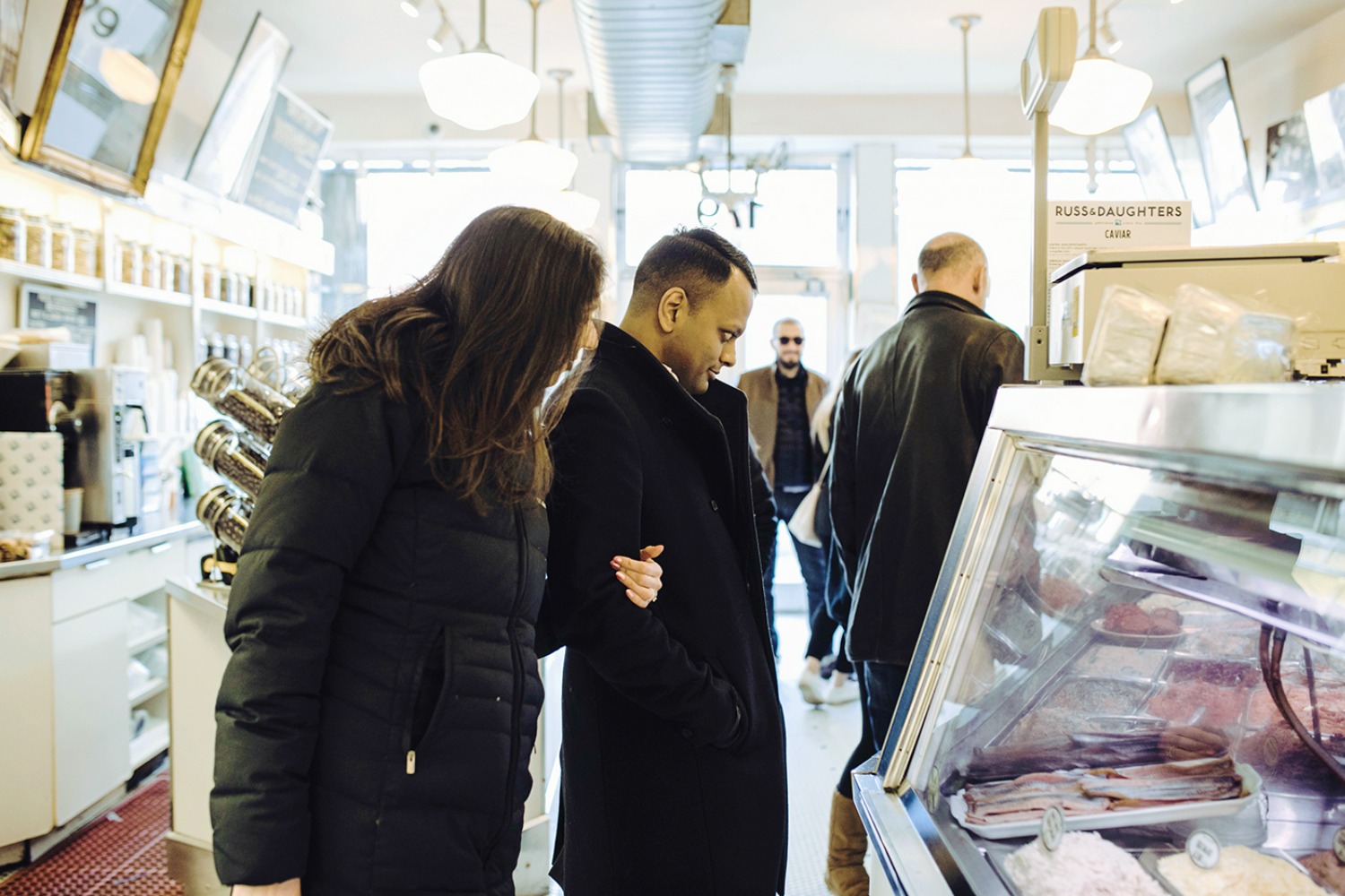 Customers look at the food display in the deli shop, Russ & Daughters