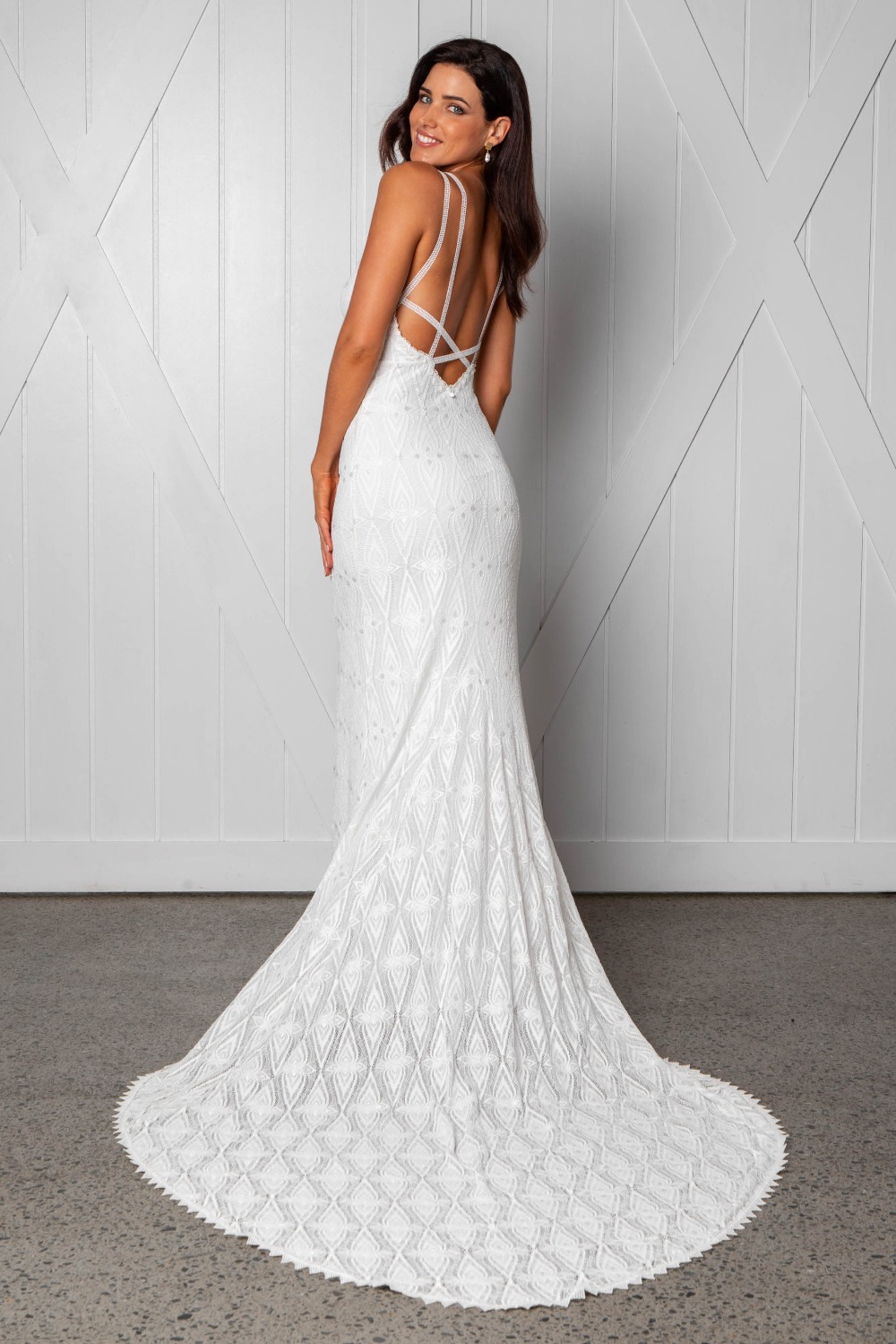 Smiling woman in white bridal gown with train