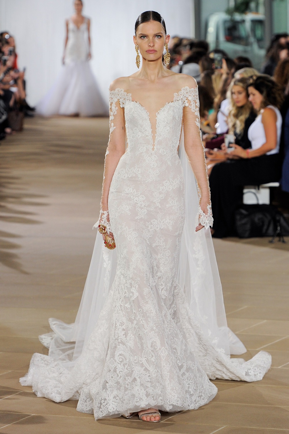 Elegant wedding dress on runway with intricate lace details